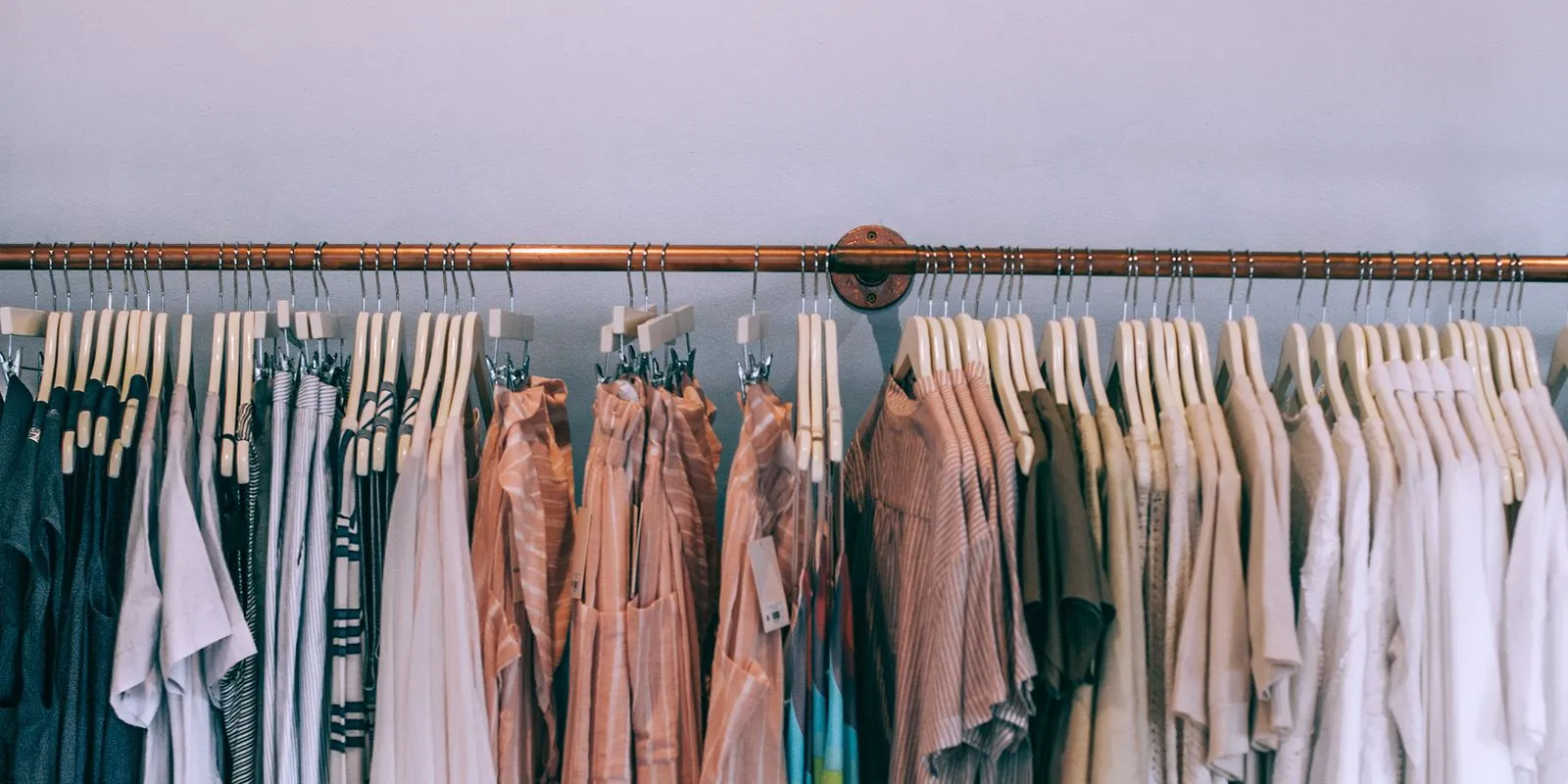 A boutique clothing rail in soft, warm colours